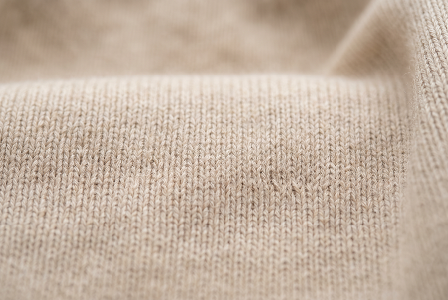 Close view of a fine flat knit in oatmeal